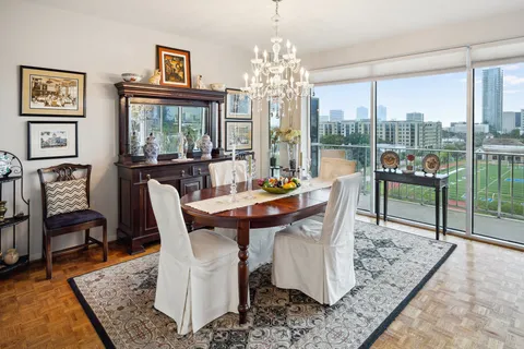 a dining room with furniture a rug and a large window