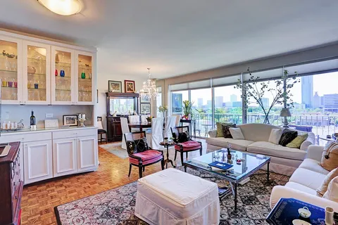 a living room with furniture and a floor to ceiling window