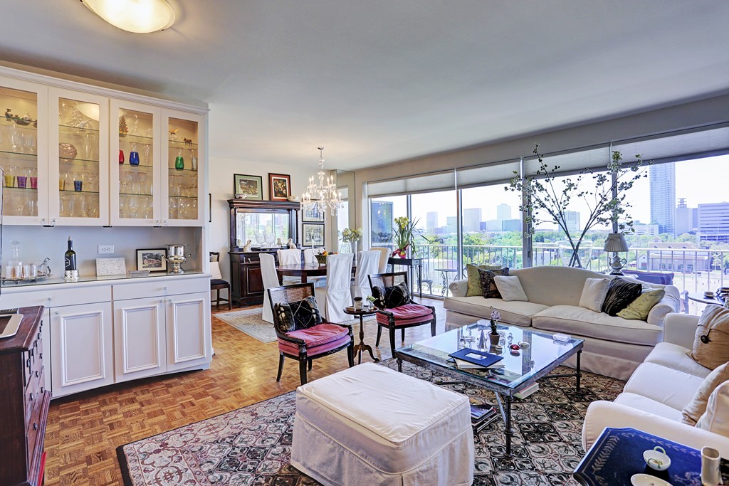 2200 Willowick Road, Unit 7B Houston, TX 77027 - Photo 17 of 32 a living room with furniture and a floor to ceiling window