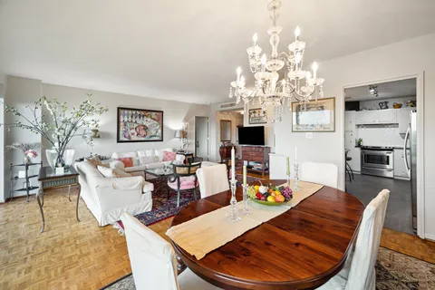 a living room with fireplace furniture and a chandelier
