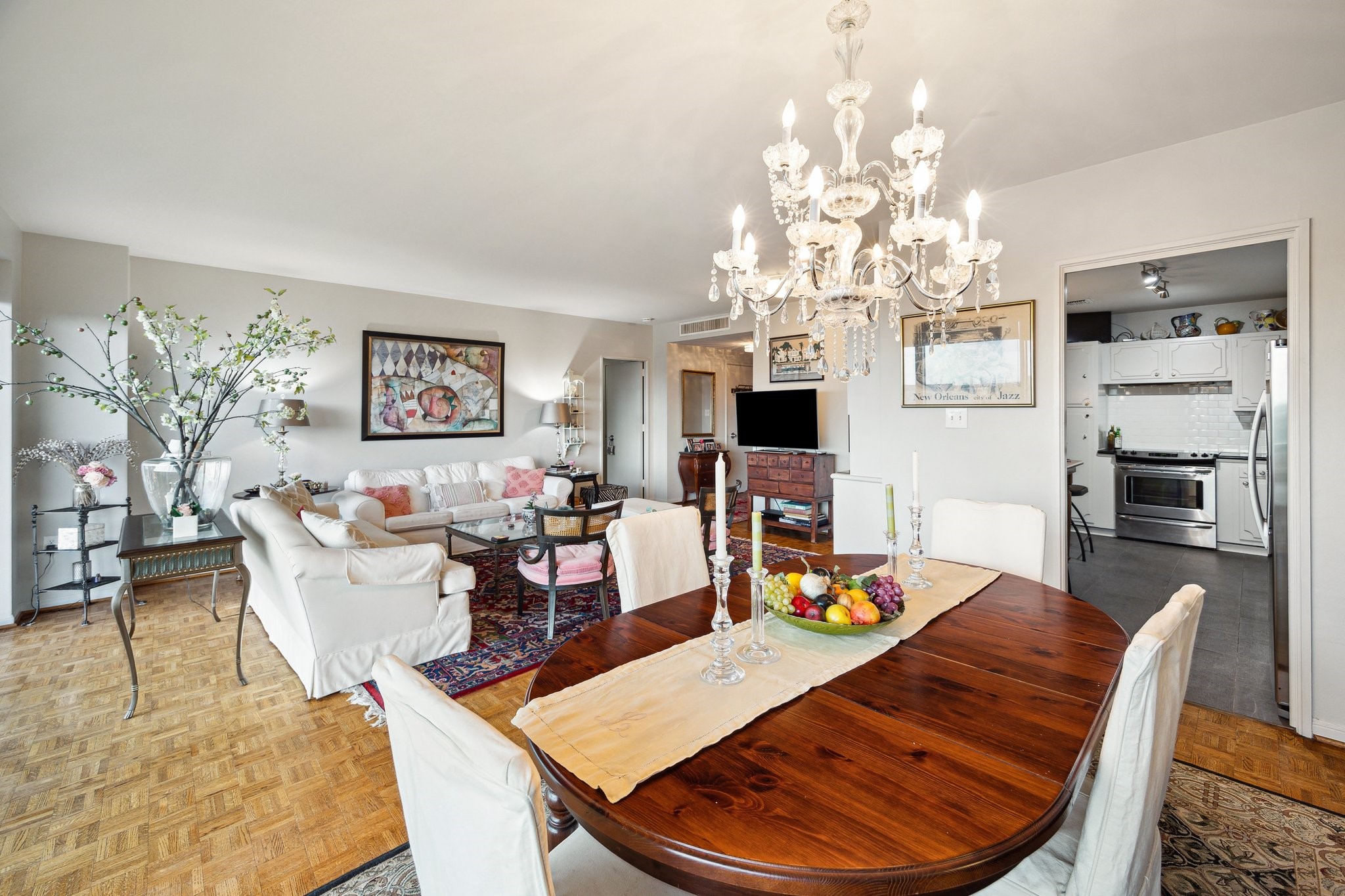 2200 Willowick Road, Unit 7B Houston, TX 77027 - Photo 18 of 32 a living room with fireplace furniture and a chandelier