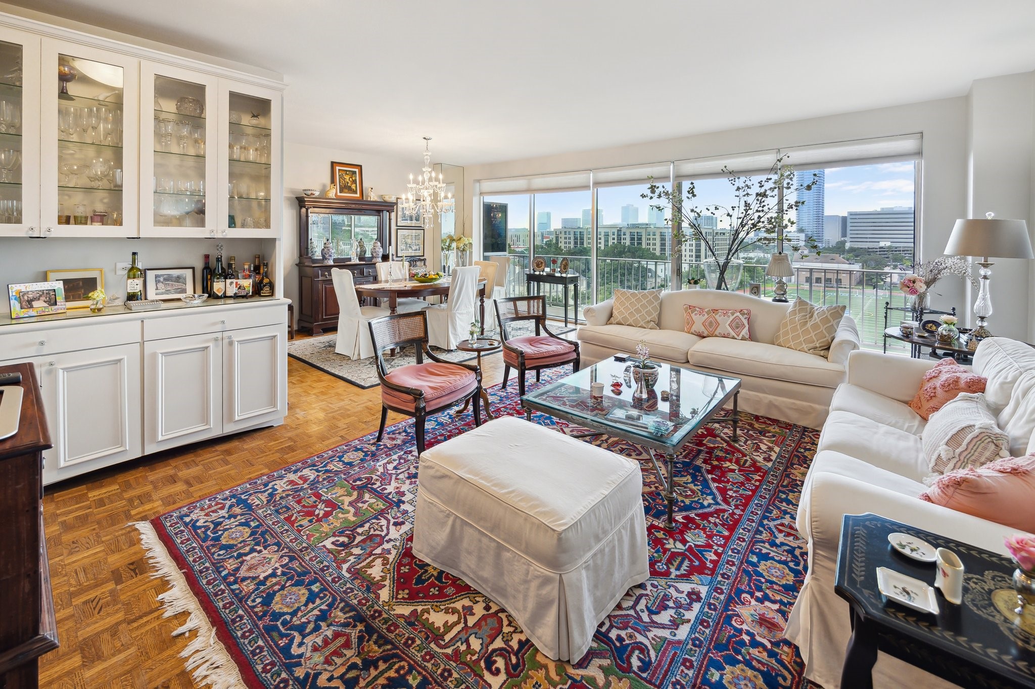 2200 Willowick Road, Unit 7B Houston, TX 77027 - Photo 3 of 32 a living room with furniture floor to ceiling window and wooden floor