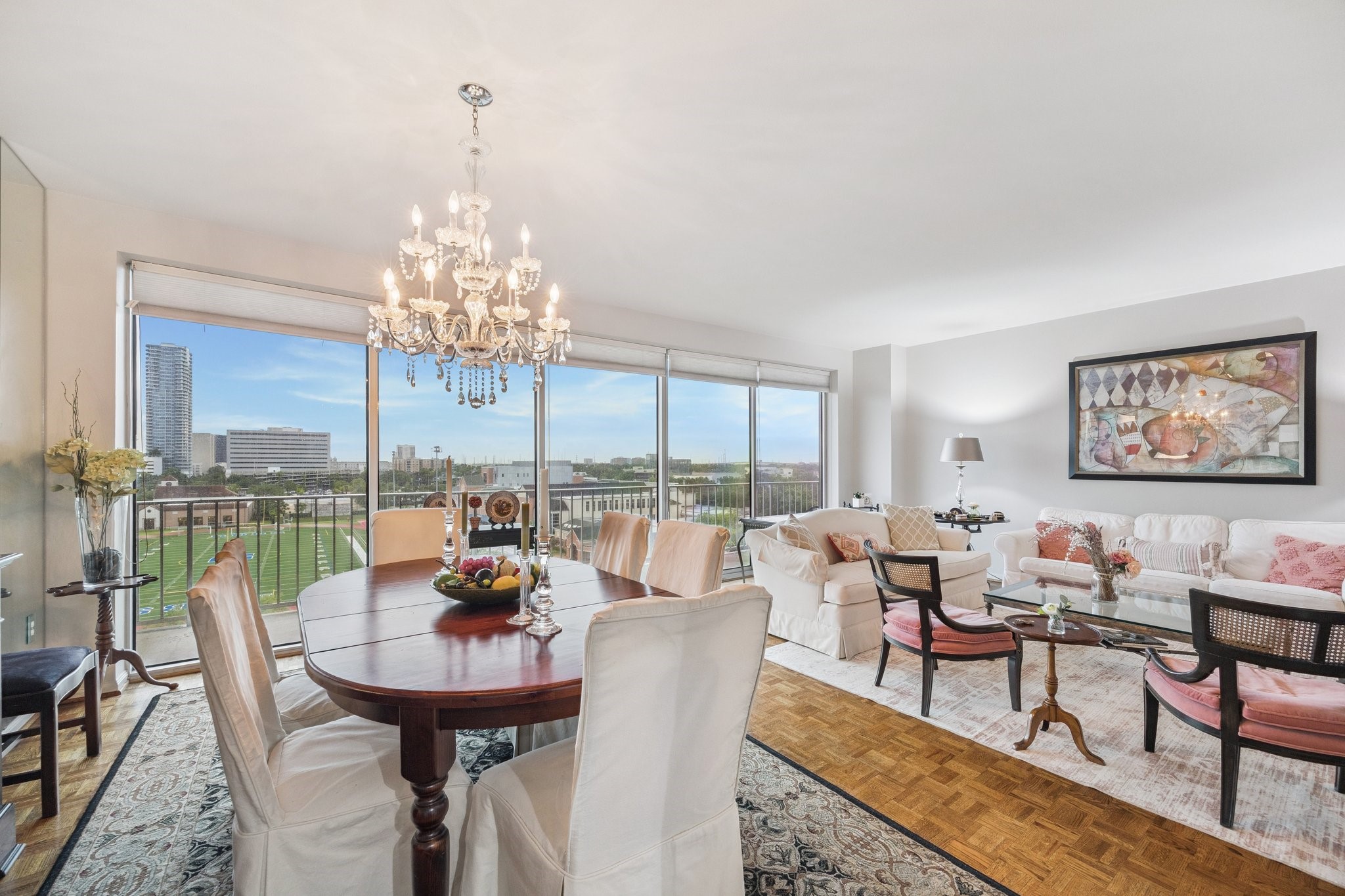 2200 Willowick Road, Unit 7B Houston, TX 77027 - Photo 5 of 27 a view of a dining room with furniture a chandelier and wooden floor