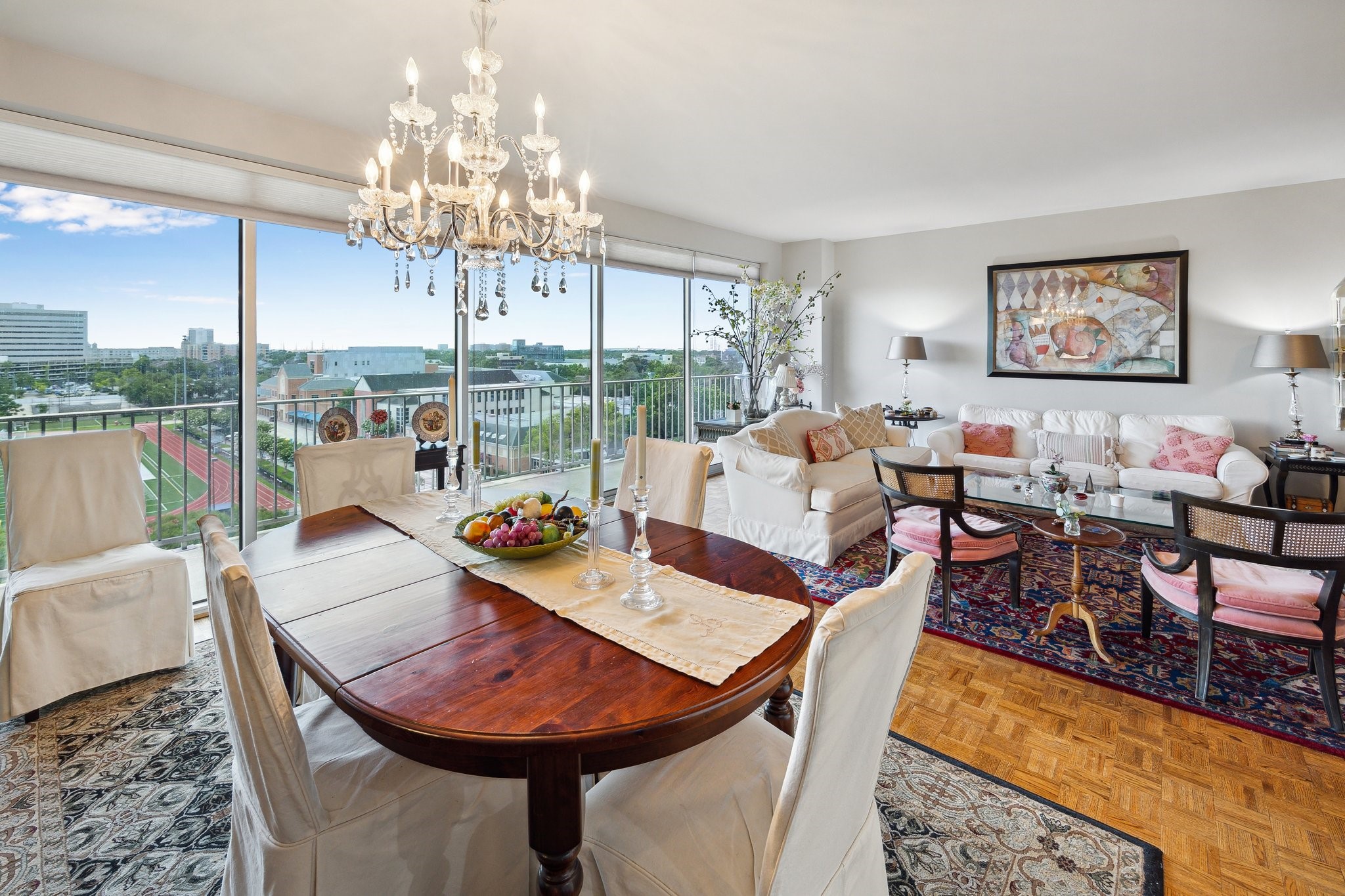 2200 Willowick Road, Unit 7B Houston, TX 77027 - Photo 6 of 32 a view of a dining room with furniture a chandelier and wooden floor