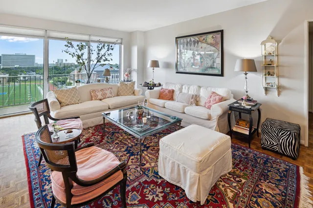 a living room with furniture and a floor to ceiling window