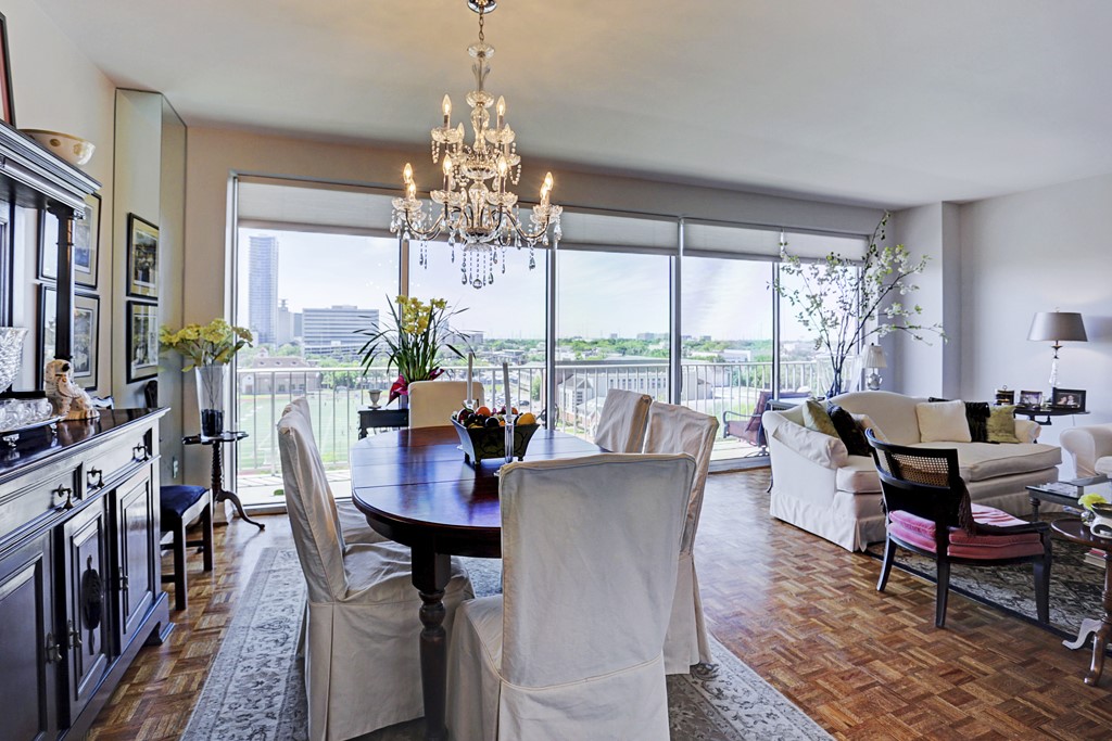 2200 Willowick Road, Unit 7B Houston, TX 77027 - Photo 8 of 32 a view of a dining room with furniture a chandelier and large windows