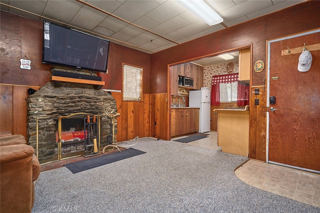 1244 Lark Road Wrightwood, CA 92397 - Photo 11 of 26 a living room with furniture mirror and a fireplace