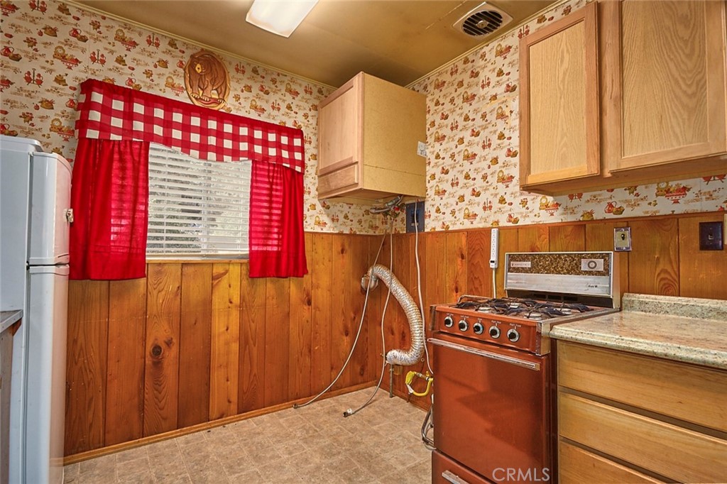 1244 Lark Road Wrightwood, CA 92397 - Photo 13 of 26 a kitchen with granite countertop a stove a sink and a microwave
