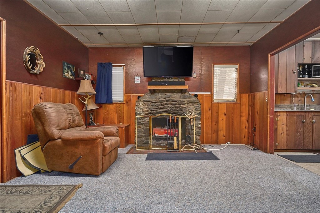 1244 Lark Road Wrightwood, CA 92397 - Photo 2 of 26 a living room with fireplace furniture and a flat screen tv