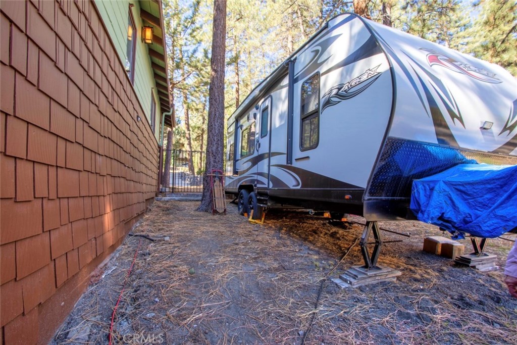1244 Lark Road Wrightwood, CA 92397 - Photo 25 of 26 a backyard of a house with barbeque oven table and chairs