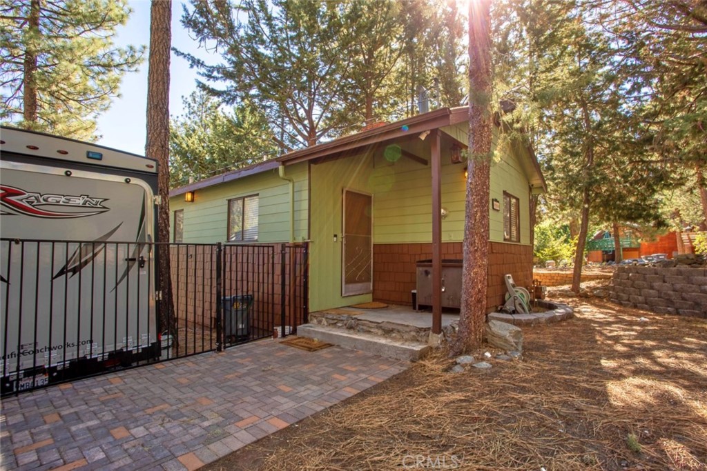 1244 Lark Road Wrightwood, CA 92397 - Photo 7 of 26 a backyard of a house with barbeque oven table and chairs