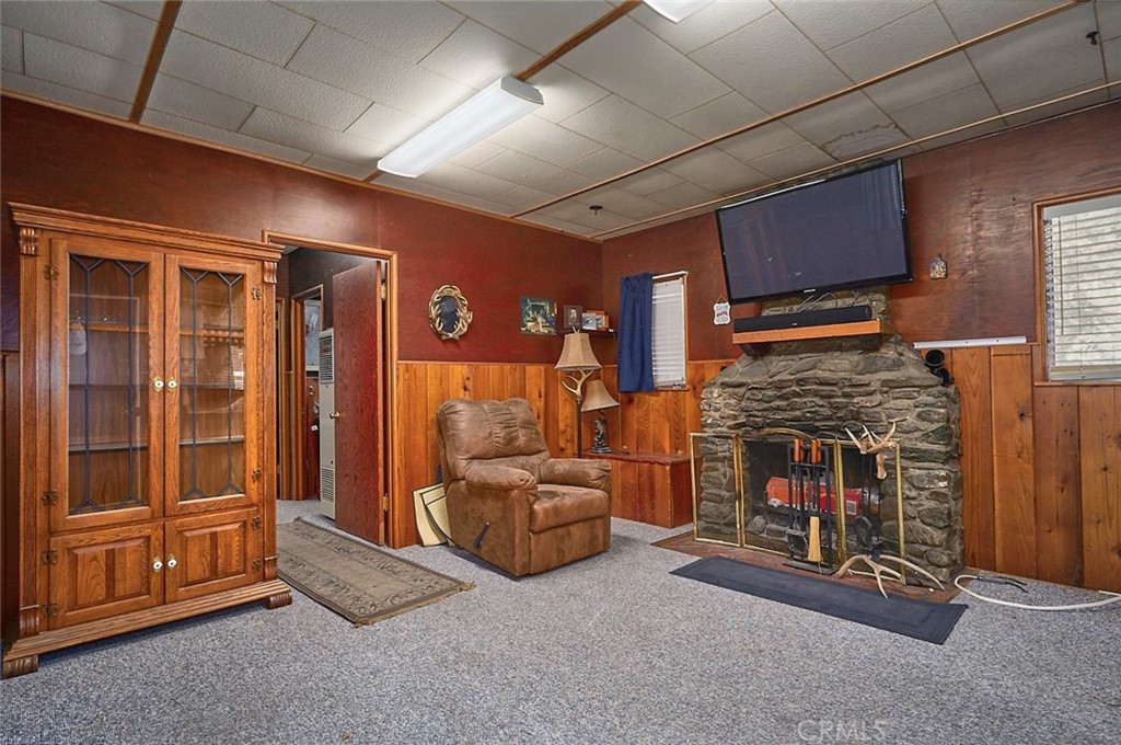 1244 Lark Road Wrightwood, CA 92397 - Photo 10 of 26 a living room with furniture and a fireplace