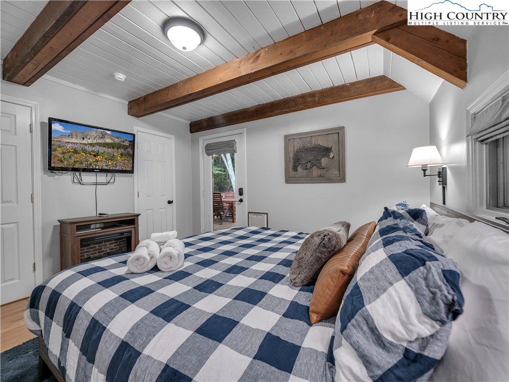 404 Charter Hills Road Beech Mountain, NC 28604 - Photo 12 of 36 a bedroom with a bed and a flat screen tv