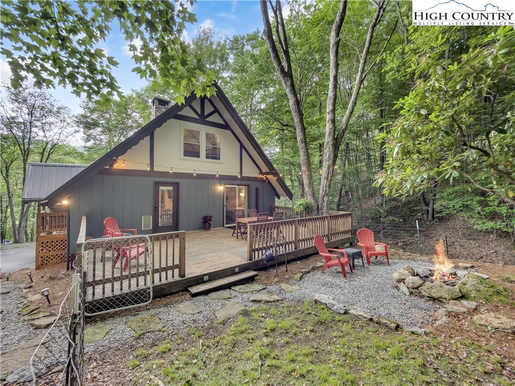 404 Charter Hills Road Beech Mountain, NC 28604 - Photo 20 of 36 a view of a house with a yard chairs and a tree