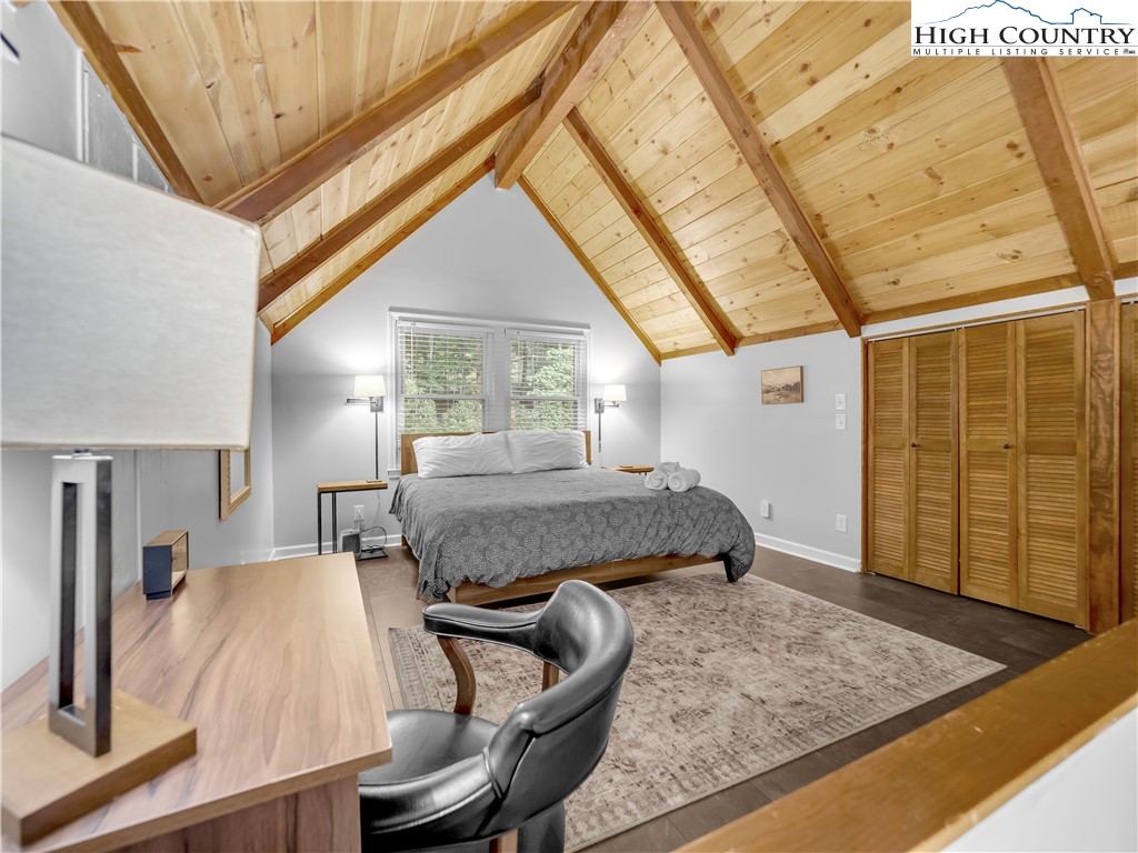 404 Charter Hills Road Beech Mountain, NC 28604 - Photo 23 of 36 a bedroom with a bed and wooden floor