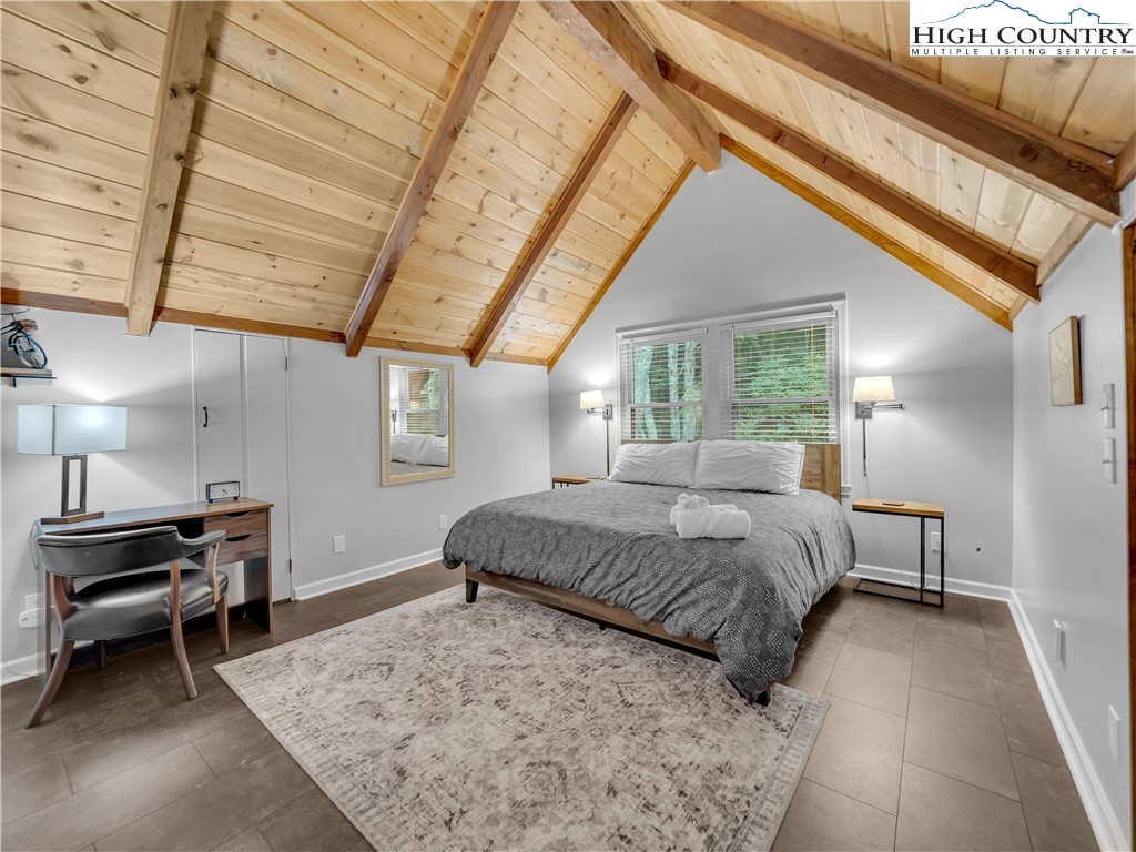 404 Charter Hills Road Beech Mountain, NC 28604 - Photo 24 of 36 a bedroom with a bed and a window