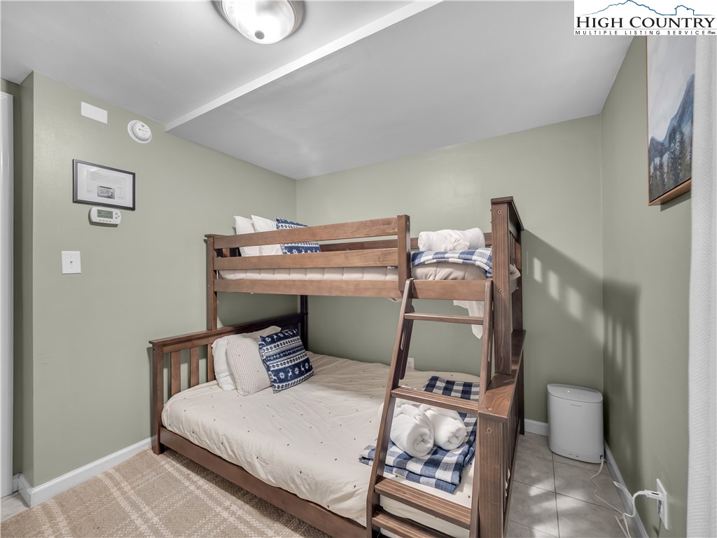 404 Charter Hills Road Beech Mountain, NC 28604 - Photo 33 of 36 a bedroom with a bed and a lamp