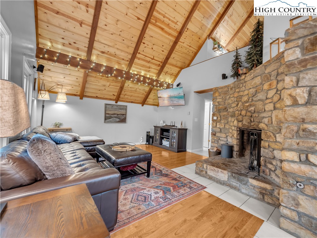404 Charter Hills Road Beech Mountain, NC 28604 - Photo 7 of 36 a living room with furniture and a fireplace