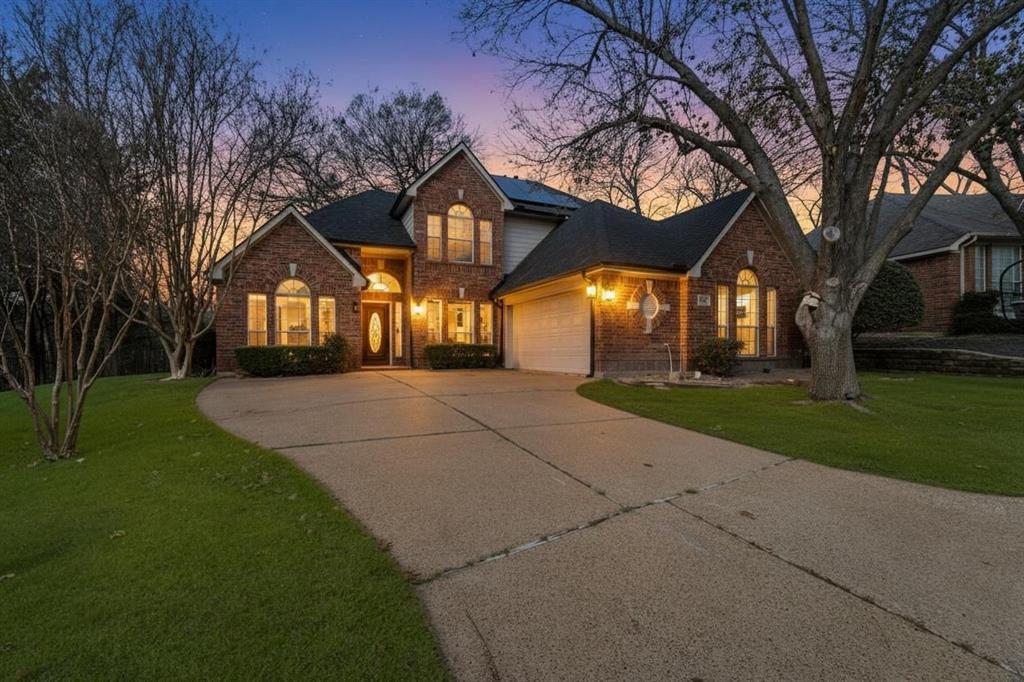 225 Freedom Court Rockwall, TX 75032 - Photo 2 of 28 a front view of a house with a yard and trees