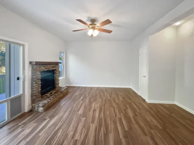 wooden floor in an empty room with a fireplace