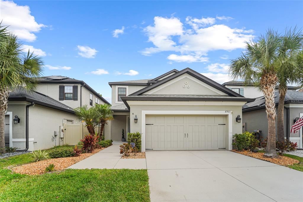 8903 Arabella Lane Seminole, FL 33777 - Photo 1 of 47 a front view of a house with garden