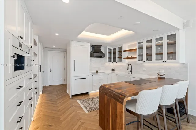 a kitchen with stainless steel appliances kitchen island granite countertop a sink and cabinets