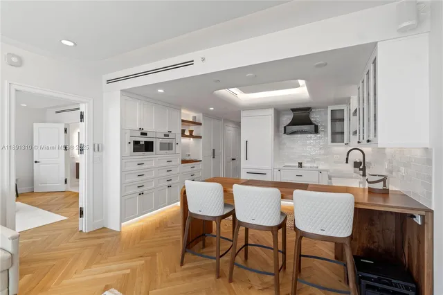 a large kitchen with a table and chairs