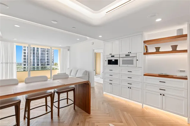 a kitchen with stainless steel appliances kitchen island granite countertop a stove a sink and a refrigerator with wooden cabinets