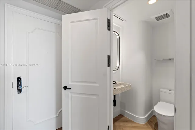 a bathroom with a granite countertop shower toilet and sink