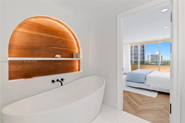 a bathroom with a bathtub and a window