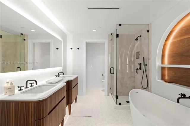 a bathroom with a tub sink and mirror