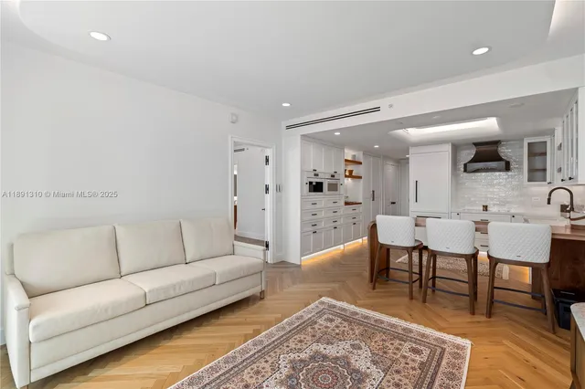 a living room with furniture a rug and a table