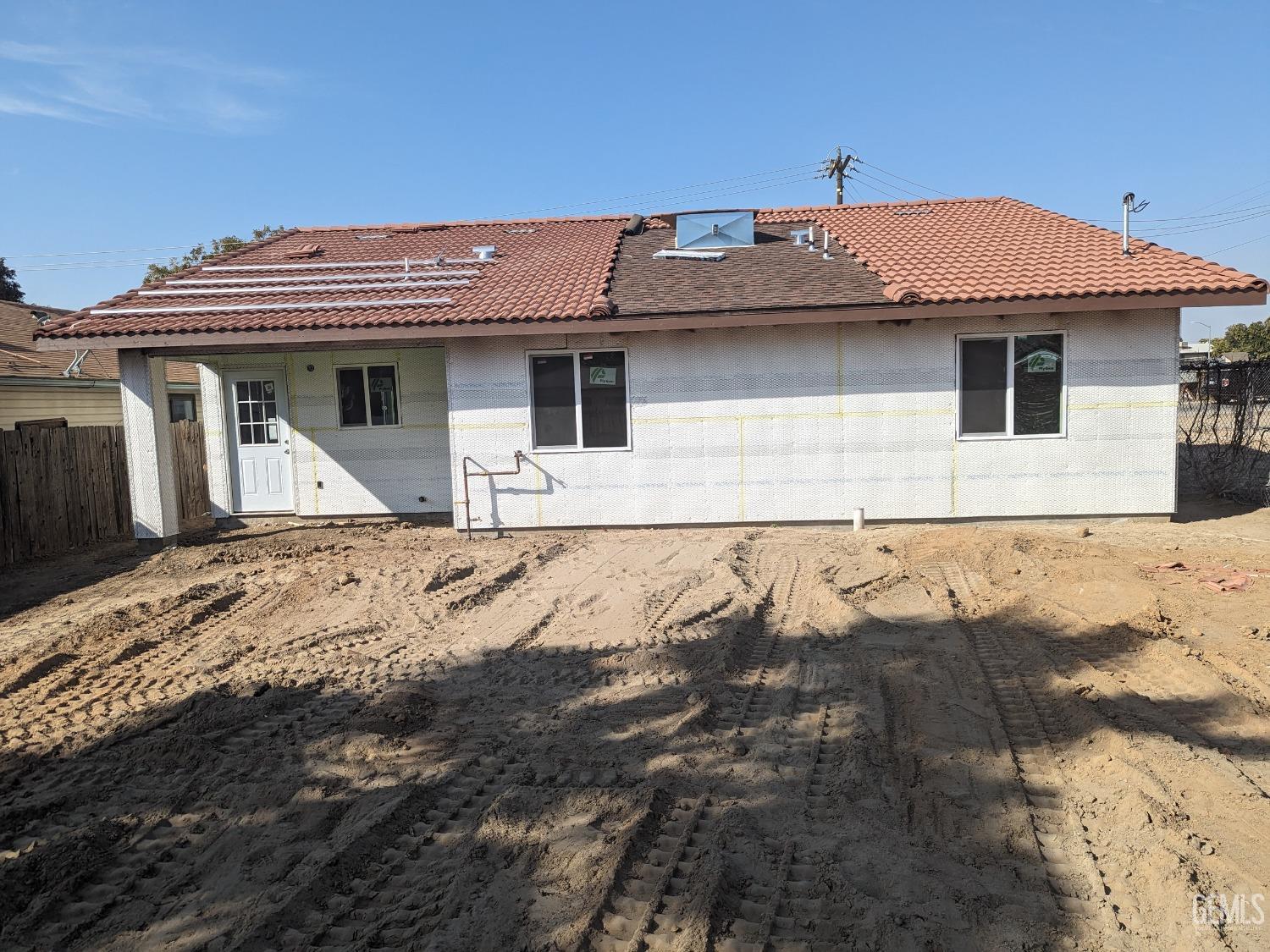 Undisclosed Address Bakersfield, CA 93308 - Photo 2 of 9 a view of a house with a wooden fence