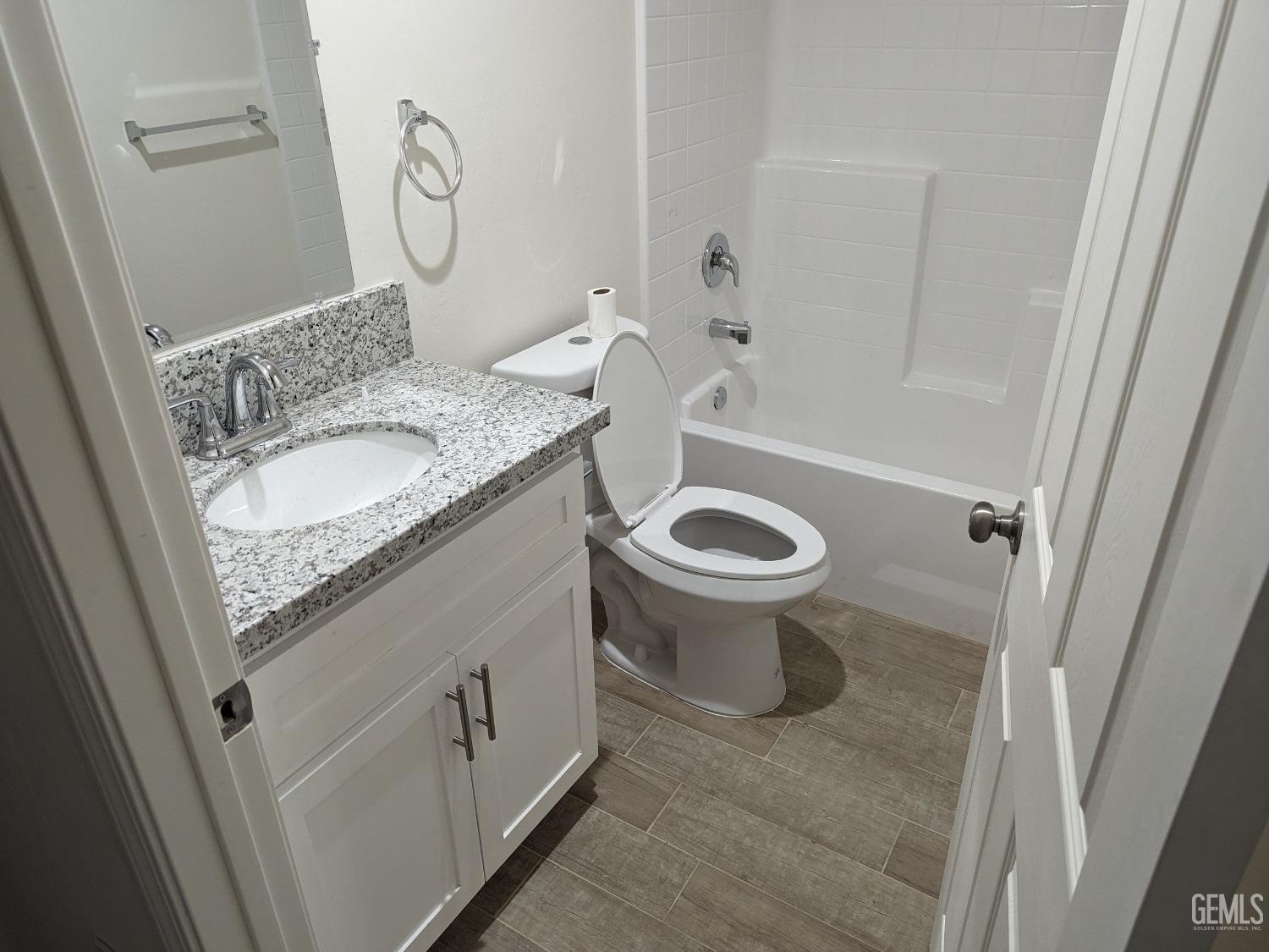 Undisclosed Address Bakersfield, CA 93308 - Photo 8 of 9 a bathroom with a granite countertop sink toilet and shower