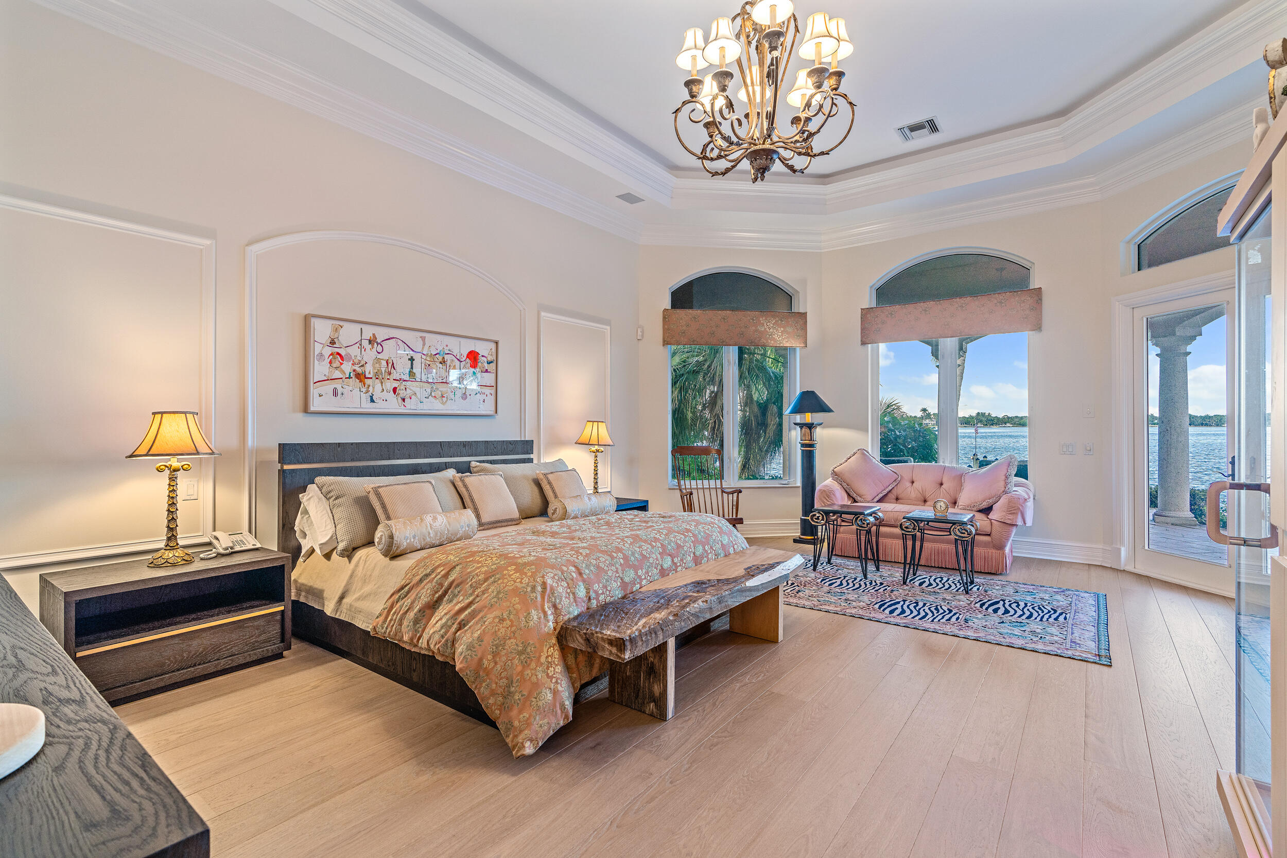 19010 Loxahatchee River Road Jupiter, FL 33458 - Photo 11 of 38 a bedroom with a bed and a chandelier