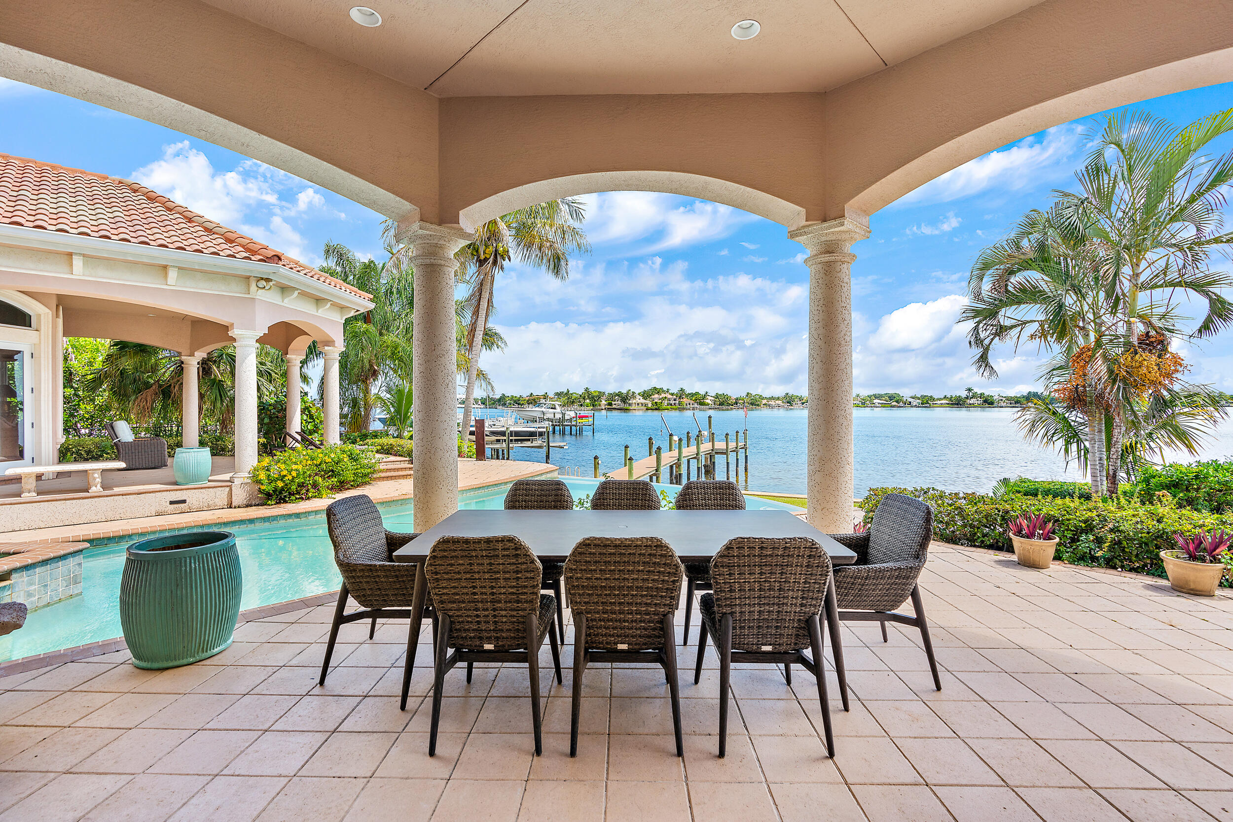 19010 Loxahatchee River Road Jupiter, FL 33458 - Photo 15 of 38 a view of a dining room with furniture a chandelier and a large window