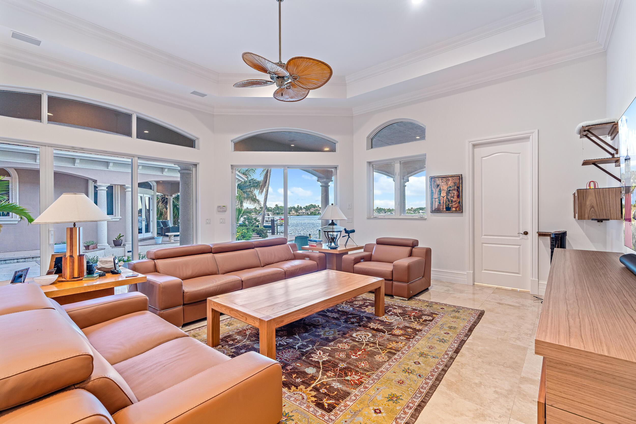 19010 Loxahatchee River Road Jupiter, FL 33458 - Photo 19 of 38 a living room with furniture a rug and a chandelier