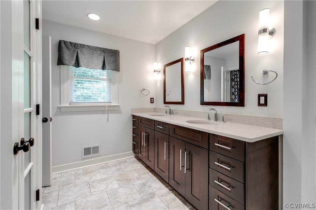 3801 East Old Gun Road Midlothian, VA 23113 - Photo 14 of 27 a bathroom with a double vanity sink and a mirror