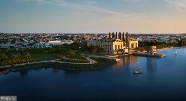 an aerial view of residential houses with outdoor space and lake view