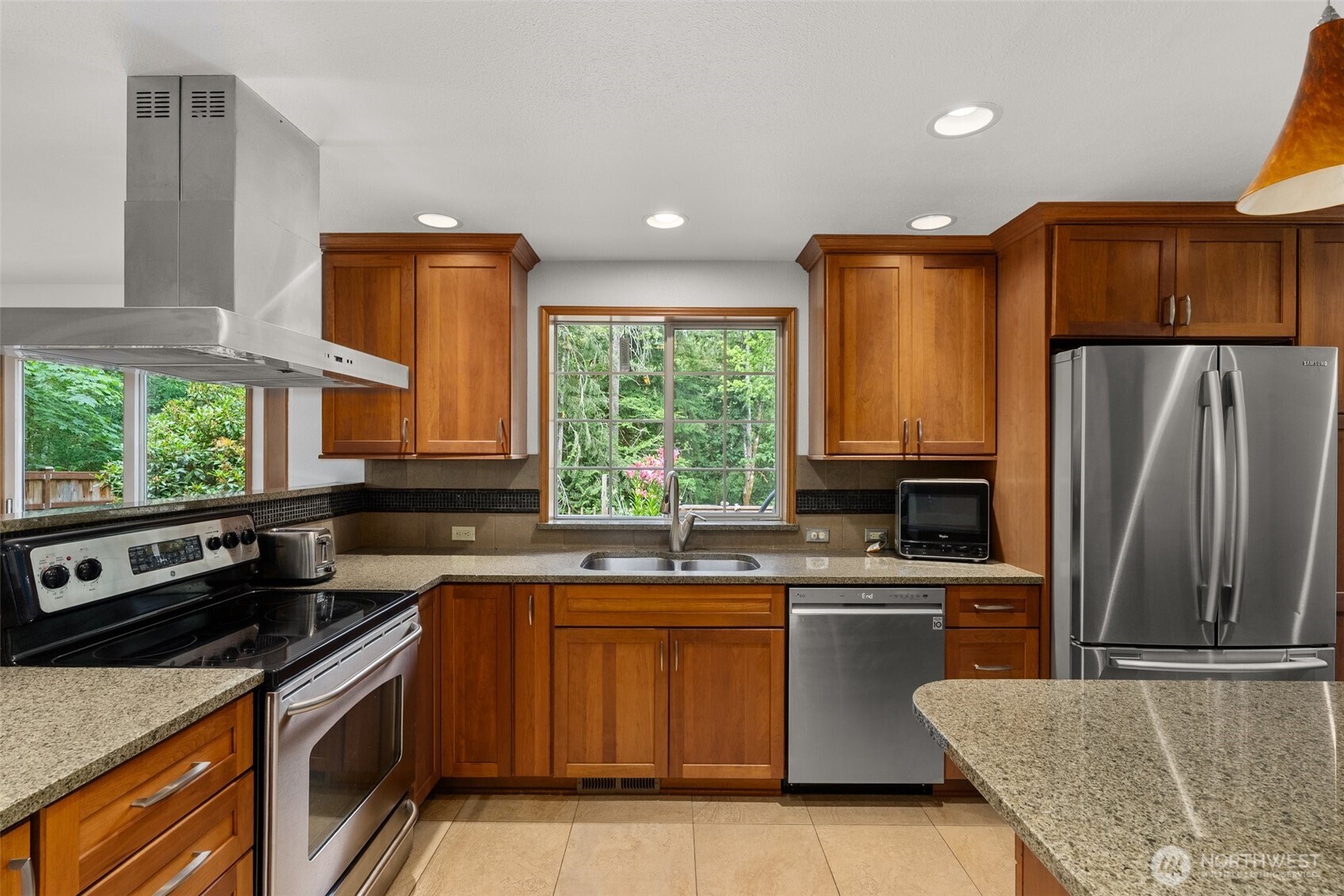 6333 Boardman Road Northwest Olympia, WA 98502 - Photo 12 of 38 a kitchen with a sink stove and refrigerator