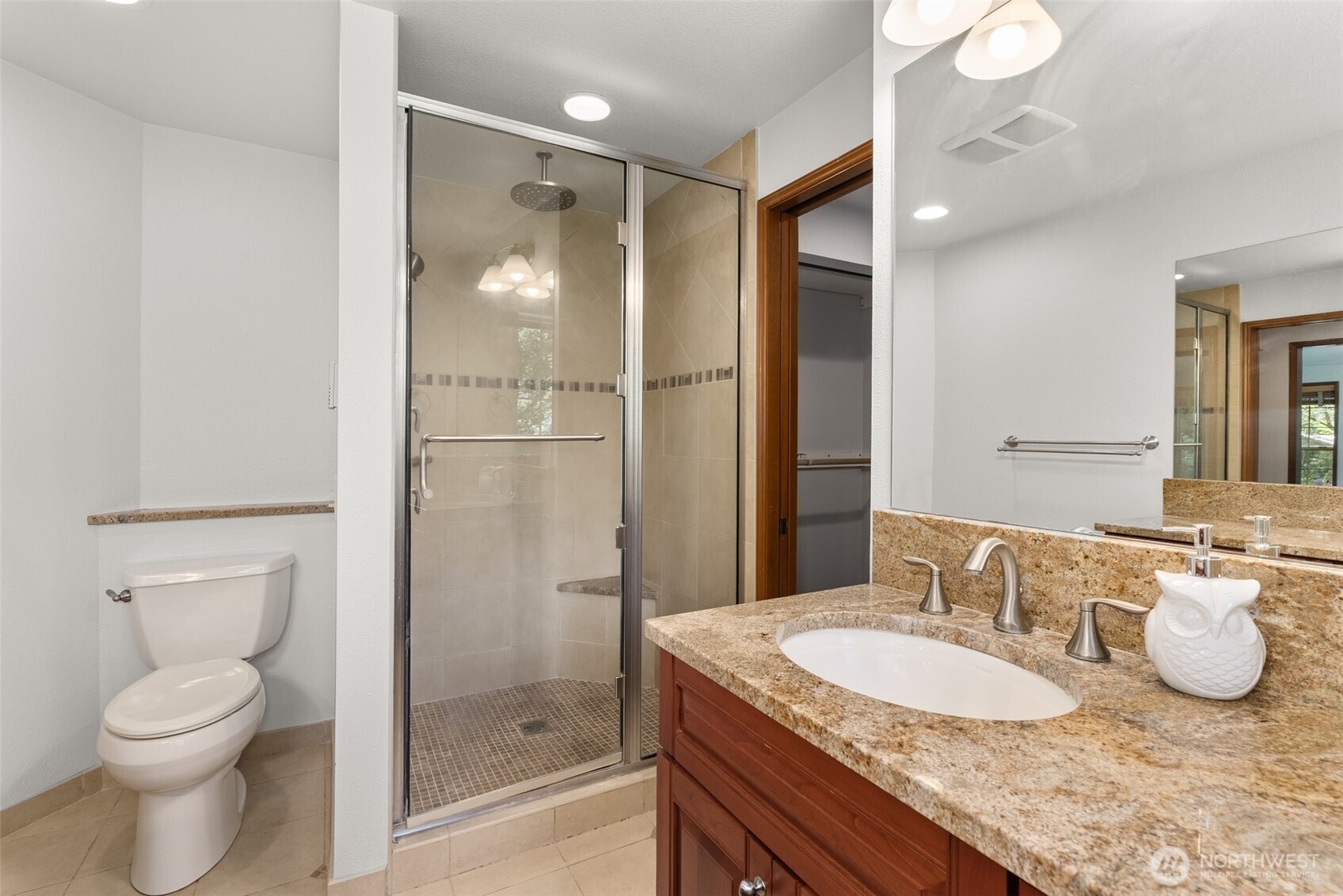 6333 Boardman Road Northwest Olympia, WA 98502 - Photo 21 of 38 a bathroom with a granite countertop sink toilet and shower