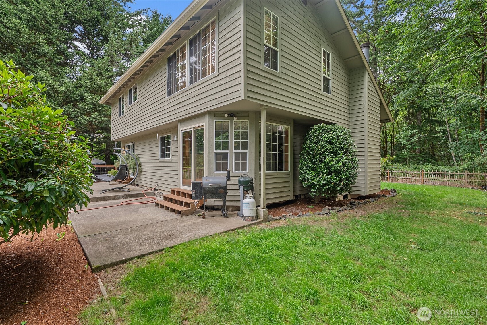6333 Boardman Road Northwest Olympia, WA 98502 - Photo 29 of 38 a view of a house with a yard and sitting area