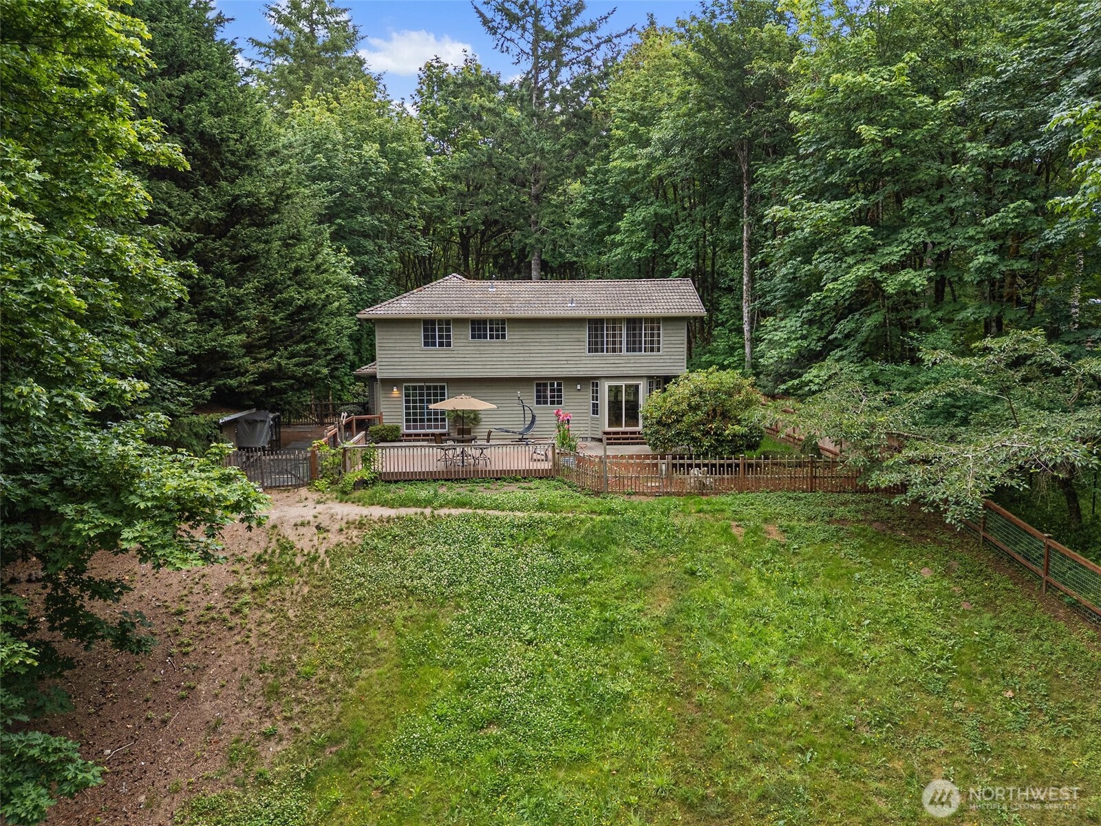 6333 Boardman Road Northwest Olympia, WA 98502 - Photo 32 of 38 a view of a house with backyard sitting area and garden
