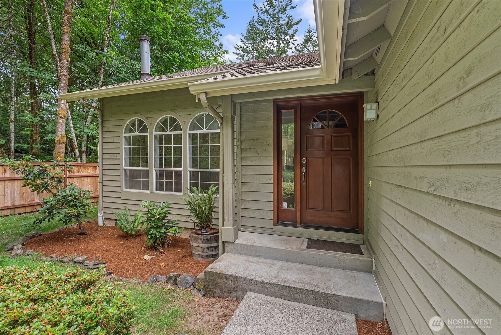 6333 Boardman Road Northwest Olympia, WA 98502 - Photo 6 of 38 a front view of a house with a garden