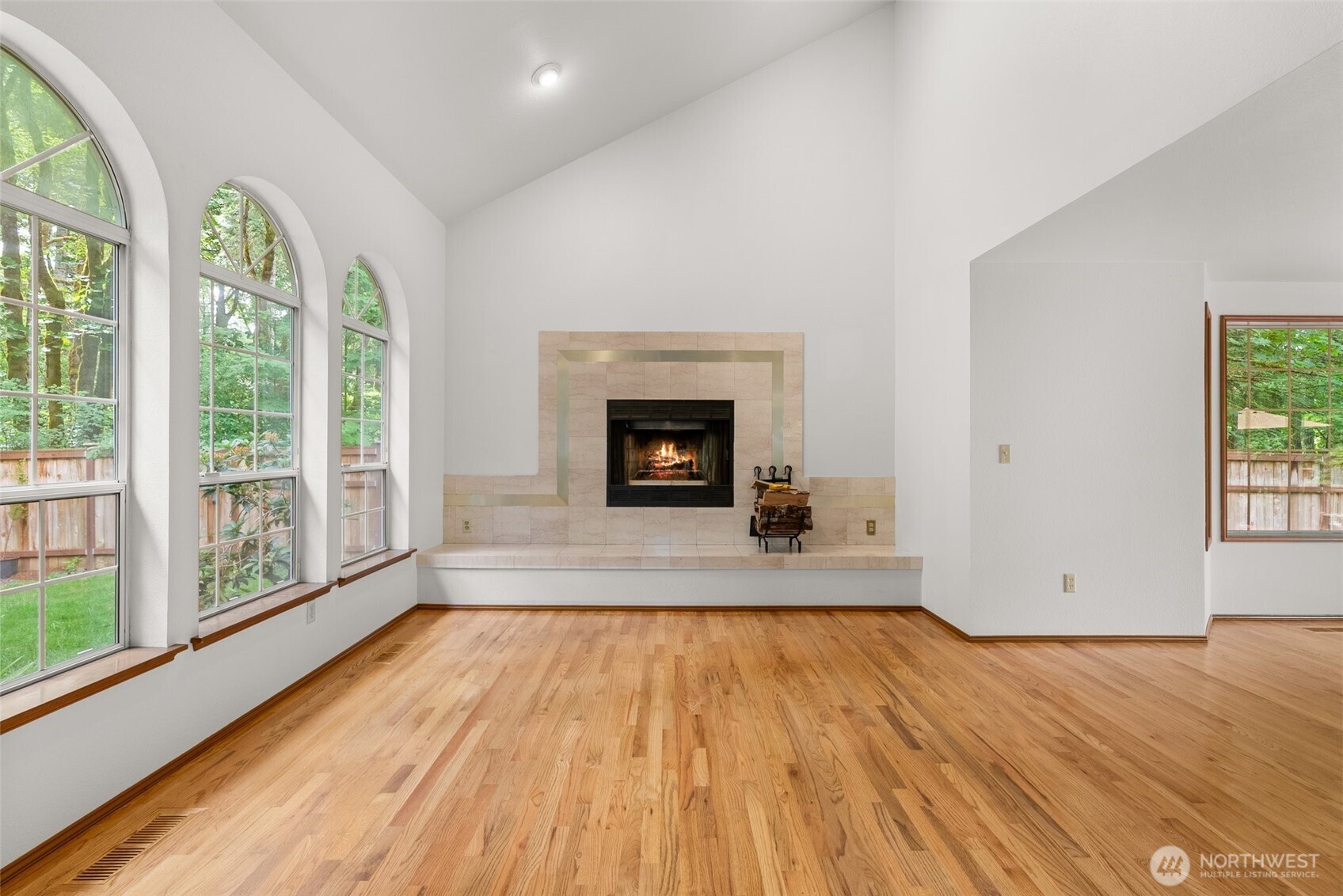 6333 Boardman Road Northwest Olympia, WA 98502 - Photo 9 of 38 a view of empty room with wooden floor and fireplace