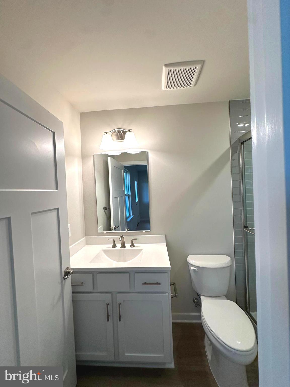 369 Huntwell W Avenue Ranson, WV 25438 - Photo 38 of 41 a bathroom with a toilet a sink a mirror and vanity