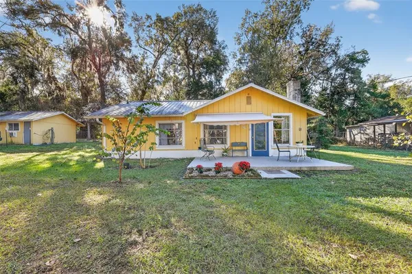 a front view of a house with a yard porch and seating space