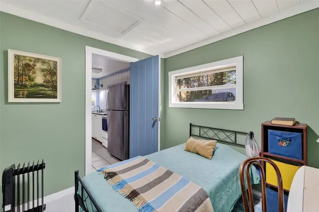 a bedroom with furniture and flat screen tv