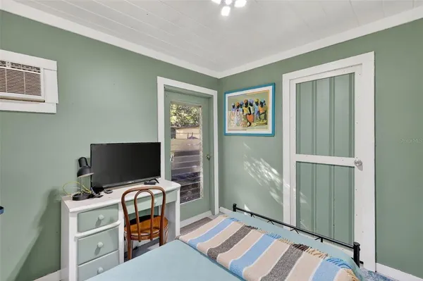 a bedroom with a bed and a chandelier