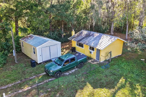 an aerial view of a house with a yard table and chairs